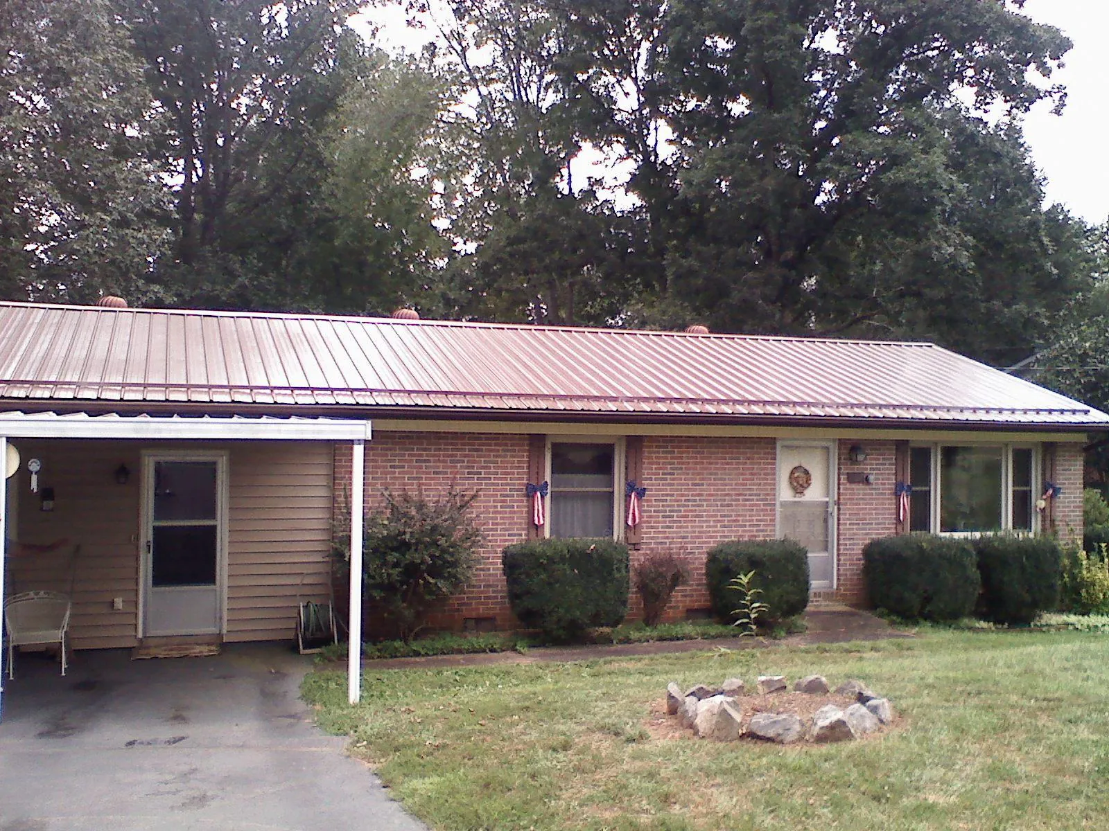 Bronze metal roof and carport on a brick ranch home — Roof Repair work by our crew in Tualatin